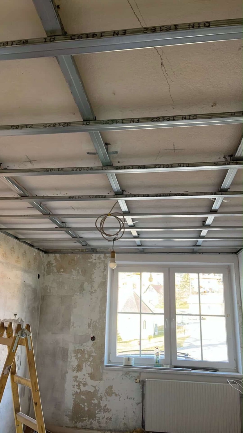 Metal substructure of a stepped suspended drywall ceiling during installation