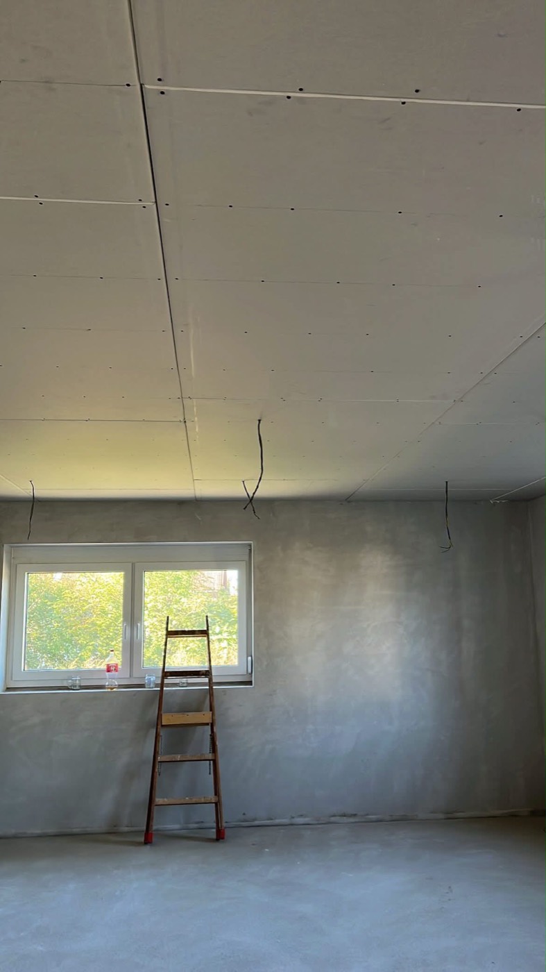 Finished suspended drywall ceiling with hidden lighting and wall niches
