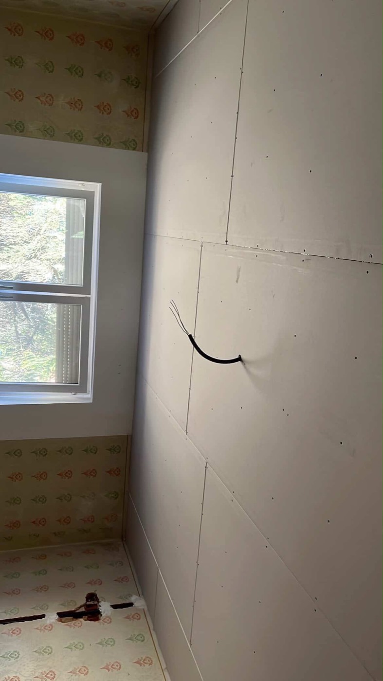 Finished drywall wall around a window, prepared for painting