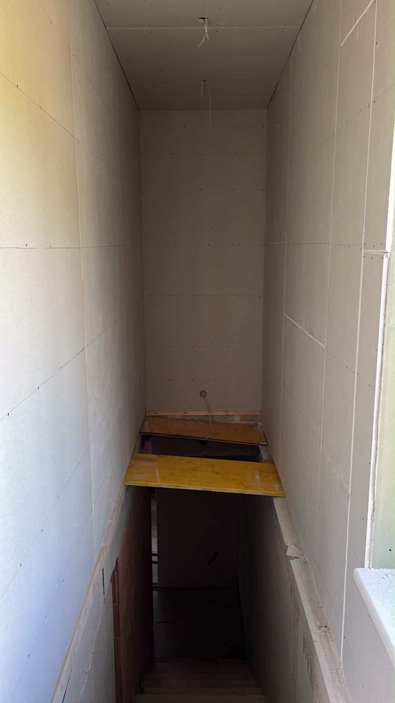Drywall-clad hallway and stairwell with a smooth surface