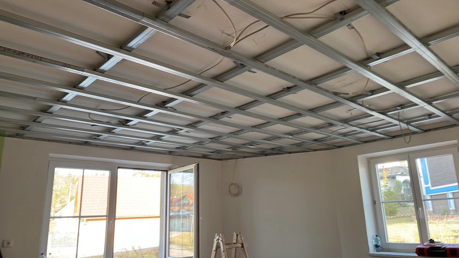 Metal frame of a suspended drywall ceiling under construction in a home in Sárvár